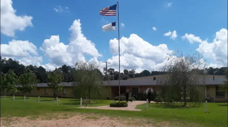 The Mercy House campus building, flagpole and lawn